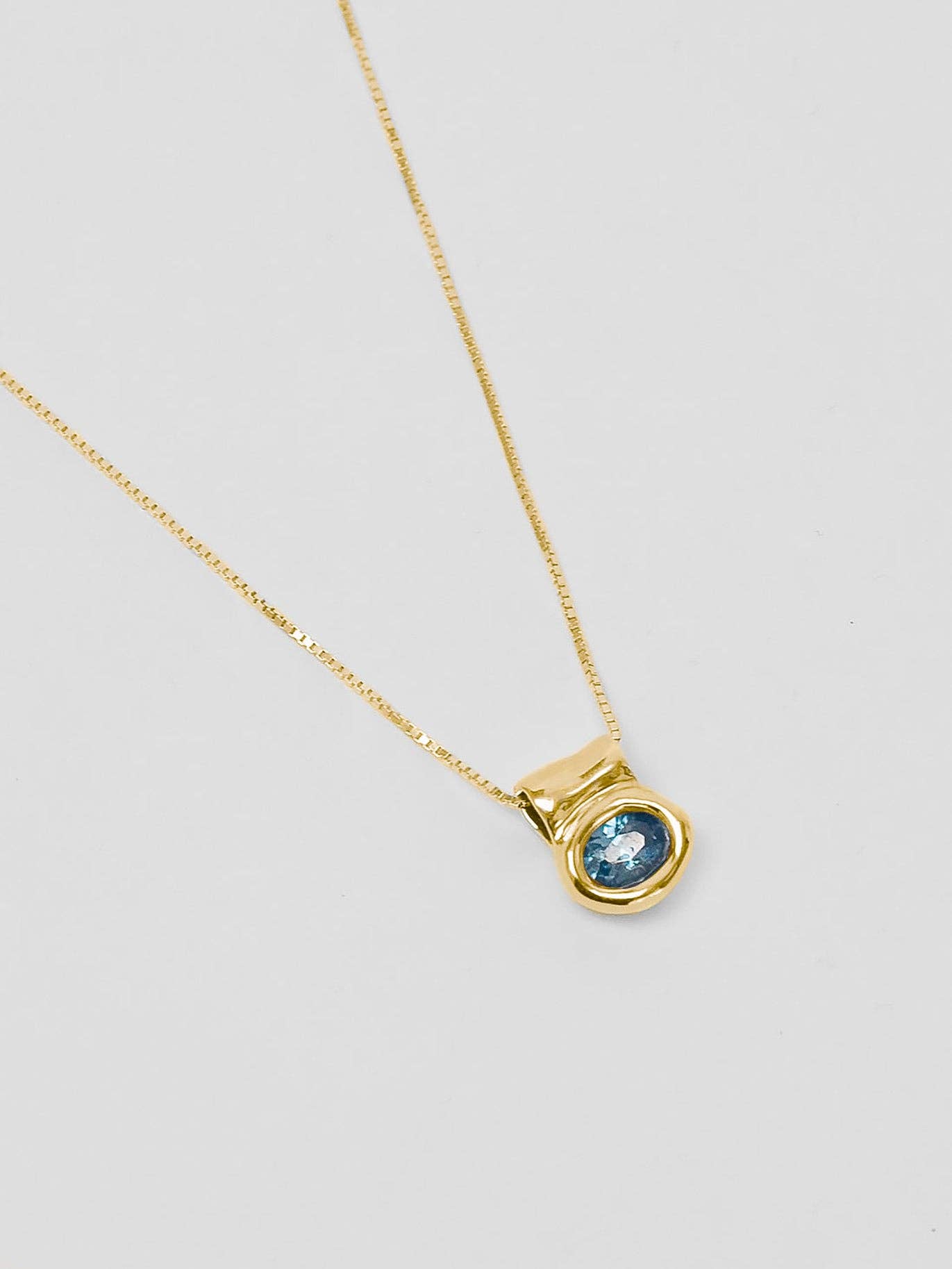 Gold Blue Topaz Oval Pendant Necklace